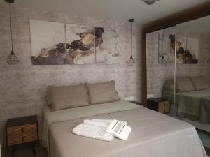 a bedroom with a bed with towels on it at PIRAGIBE FROTA AGUIAR in Rio de Janeiro