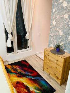 a room with a colorful rug and a window at Radisson Charm Studio in Bucharest
