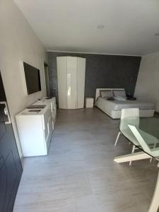 a bedroom with a bed and a desk and a table at Foresterie Lombarde B&B Villa Ambra in Limbiate