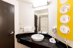 a bathroom with a sink and a mirror at Motel 6-Irving, TX - DFW Airport North in Irving