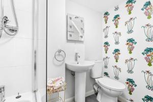 a bathroom with a toilet and a sink at Crooks Cottage - Charming, characterful, glorious views from the garden in Dittisham +33 photos