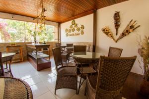 a dining room with a table and chairs in a room at Pousada da Leide in Fernando de Noronha