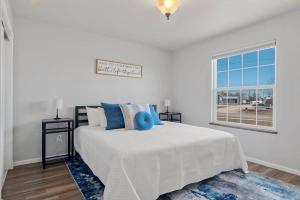 a white bedroom with a bed and a window at Pet Friendly 2 King Beds Foosball Table in Rapid City