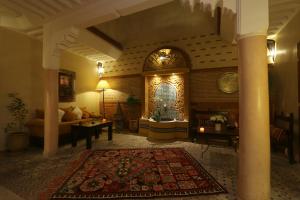 a large living room with a couch and a table at Riad Andalla in Marrakesh