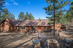 a log cabin with chairs and a tree at Tatanka Hideaway Hot Tub Pool Table Massive Space in Custer