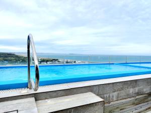 a swimming pool with a view of the ocean at SYRAH Vistas by depptö in Punta del Este +12 photos