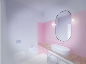 a pink bathroom with a sink and a mirror at Spacebility Beach - self check-in in Quartu SantʼElena