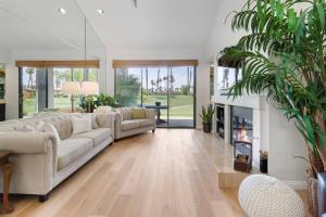 a living room with a couch and a fireplace at Sunny Palm Desert Escape on Golf Course in Palm Desert