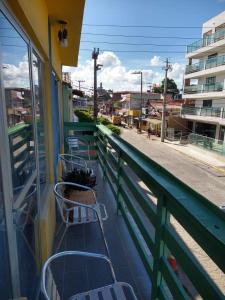 a balcony with chairs and a view of a street at Pousada Porto Seguro in Porto De Galinhas