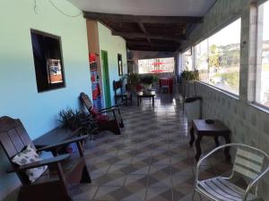 a room with chairs and tables in a building at Pousada Porto Seguro in Porto De Galinhas