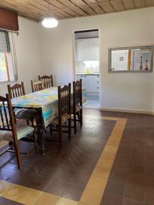 a dining room and kitchen with a table and chairs at Las Margaritas in La Coronilla