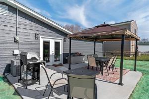 a patio with a table and an umbrella at Gazebo 4BR Ping Pong Arcade Room in Rapid City