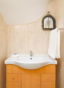 a bathroom with a white sink and a mirror at CRALS - Casa da Praceta in Braga