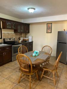 a kitchen with a table and chairs and a refrigerator at Apartamento #3 Portal de Occidente in Quetzaltenango