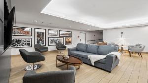 a living room with a blue couch and chairs at 315 LoSo Hotel Airport in Charlotte