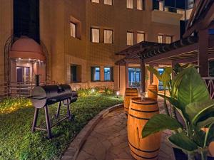 a grill in a courtyard of a building at night at Vibe Hotel Singapore Orchard in Singapore