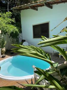 a small blue swimming pool in front of a house at Villa de Bemposta-Trancoso in Trancoso