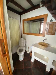 a bathroom with a toilet and a sink at The Hidden Escapes- Unique Tiny Home on Bingin Beach with Breathtaking Ocean & Sunset Views in Uluwatu