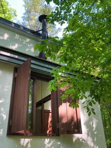 a window on the side of a house at Tatehata House. Private Sauna. Outdoor Bath. in Kita-karuizawa