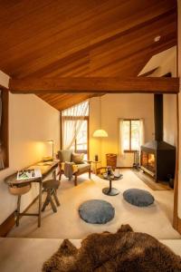 a room with a living room with a fireplace at Tatehata House. Private Sauna. Outdoor Bath. in Kita-karuizawa