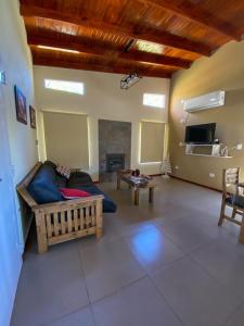 a living room with a couch and a fireplace at Pinares del Norte in Federación