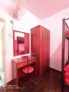 a red desk with a chair and a mirror at PD Laguna Homestay Red in Port Dickson