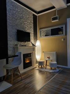 a living room with a fireplace and a tv at Glamour Wellness Apartments in Zagreb
