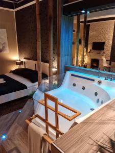 a jacuzzi tub in a room with a bed at Glamour Wellness Apartments in Zagreb