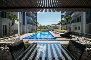 a swimming pool in the middle of a building at Mantra Beach condominium M116,M140 in Ban Phlong Sawai
