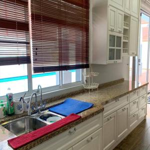 a kitchen with a sink and a counter top at Santai Homestay Jb in Johor Bahru