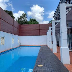 a swimming pool next to a building at Santai Homestay Jb in Johor Bahru