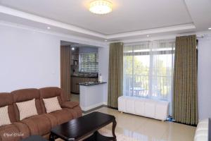 a living room with a couch and a table at Luxe Furnished Premium Unit in Meru