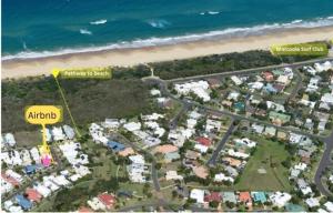 an aerial view of a resort with the beach at Eugarie Seaside Guesthouse in Marcoola