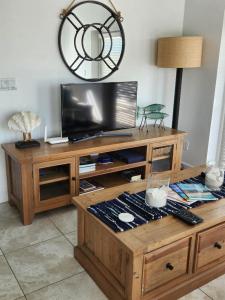 a wooden entertainment center with a flat screen tv at The Tides, Grace Bay in Providenciales