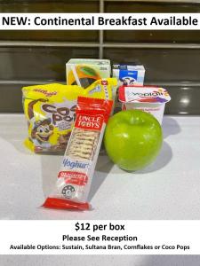 a green apple sitting next to some food on a counter at Leumeah Lodge in Canberra