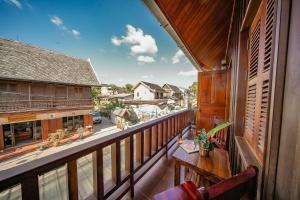 an outdoor balcony with a view of a street at Villa Wanika in Luang Prabang