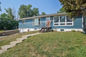 a blue house with stairs in front of it at Roomy 5 Bed 3 Bath Fire Place Large Outdoor Space in Rapid City