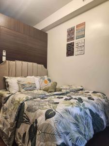 a bedroom with a bed with a comforter on it at air residences in Manila