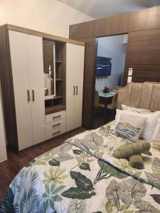 a bedroom with a large bed and a desk at air residences in Manila