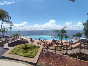 a swimming pool with a view of the ocean at Tropical Executive Vista Ponta Negra in Manaus