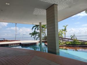 a swimming pool with a view of the ocean at Tropical Executive Vista Ponta Negra in Manaus