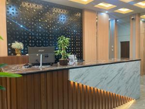 a lobby with a counter with a laptop on it at The Bonte Hotel in Puunggolaka