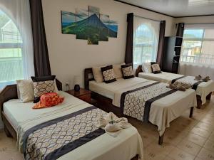 a room with four beds in a room at HOTEL DEL RiO in Liberia