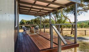 a wooden deck with a pergola on a house at Petit Manor in Cromer