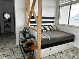 a bedroom with a bunk bed and a window at Pomme Surette in Sainte-Anne