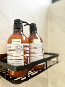 two bottles of hot sauce sitting on a shelf at Imperio Residences Private Bathtub or Jacuzzi by Nestcove in Melaka