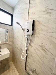 a bathroom with a soap dispenser on the wall at Imperio Residences Private Bathtub or Jacuzzi by Nestcove in Melaka