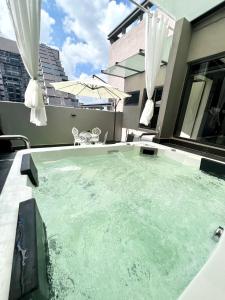 a hot tub on the balcony of a house at Imperio Residences Private Bathtub or Jacuzzi by Nestcove in Melaka