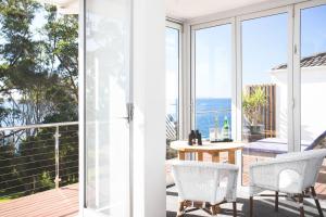 two views of the ocean from the balcony of a house at Bannisters by the Sea Mollymook in Mollymook