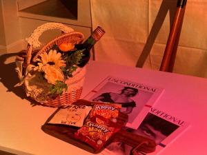 a table with a book and a basket of flowers and a magazine at DDUBLE Square in Daegu